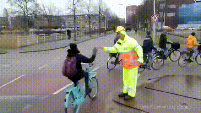 Giving 'high-5' to several bike commuters
